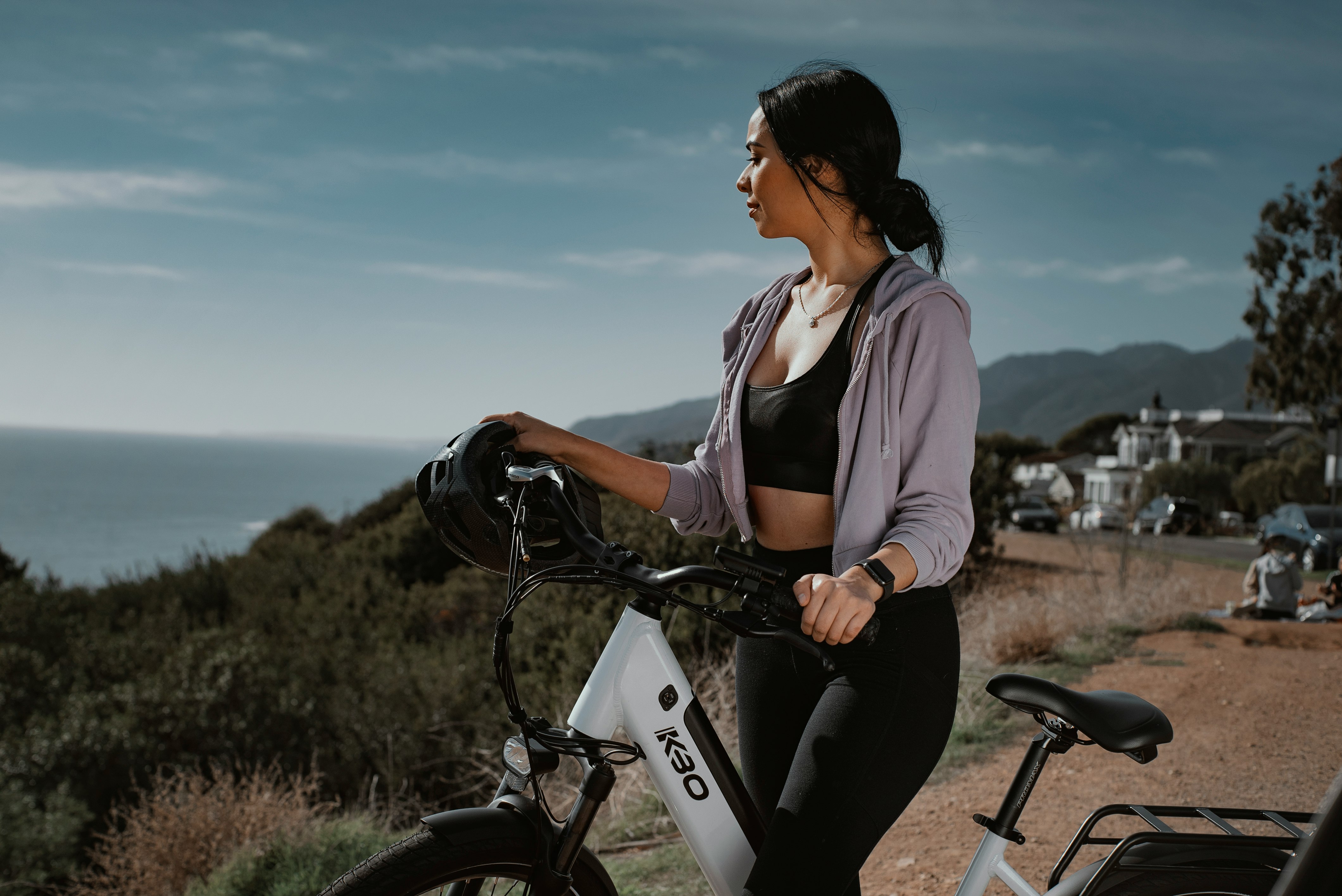 woman in white shirt riding on black bicycle during daytime